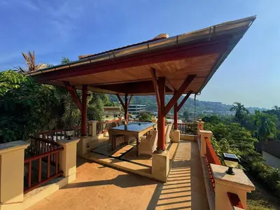a wooden pavilion with a picnic table on a roof at Kata Sea Cloud Villa\u534a\u5c71\u6d77\u666f\u72ec\u680b\u522b\u5885 in Kata Beach