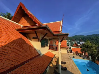 a house with an orange roof and a swimming pool at Kata Sea Cloud Villa\u534a\u5c71\u6d77\u666f\u72ec\u680b\u522b\u5885 in Kata Beach
