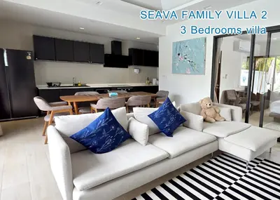 a living room with a white couch with blue pillows at Seava House Ao-Nang Krabi in Ao Nang Beach