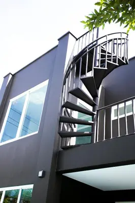 a spiral staircase on the side of a building at Seava House Ao-Nang Krabi in Ao Nang Beach