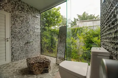 a bathroom with a toilet and a large window at Seava House Ao-Nang Krabi in Ao Nang Beach
