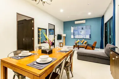 a dining room and living room with a table and chairs at Seava House Ao-Nang Krabi in Ao Nang Beach