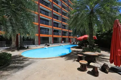 a swimming pool in front of a building at Studio 777 condo MaiKhao in Phuket Town