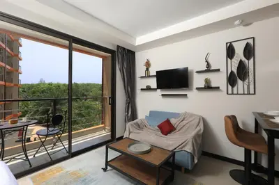 a living room with a view of a balcony at Studio 777 condo MaiKhao in Phuket Town