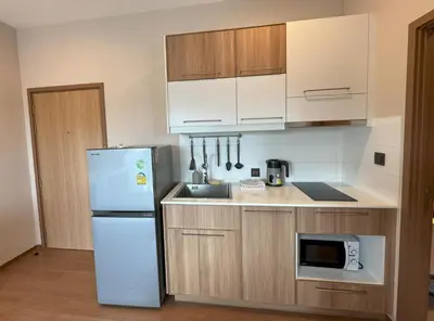 a kitchen with a white refrigerator and a microwave at Private apartment Title V Condo by Lofty in Rawai Beach