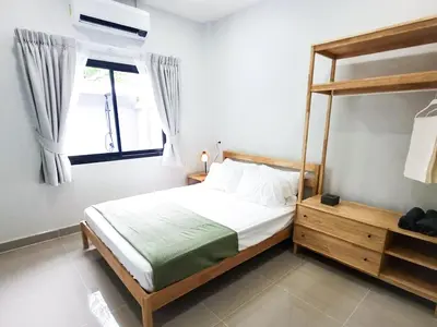 a bedroom with a bed and a large window at Calm & Cozy Vacation House in Rawai Beach
