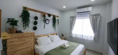 a bedroom with a bed and a window at Calm & Cozy Vacation House in Rawai Beach