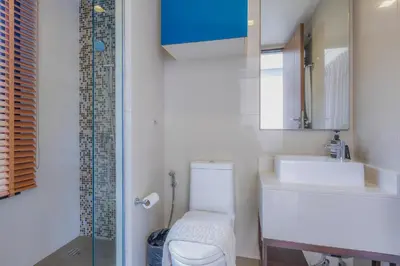 a bathroom with a toilet and a sink and a shower at Laguna Parkside by Triple8 Asia in Laguna Phuket