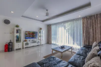 a living room with a couch and a table at Laguna Parkside by Triple8 Asia in Laguna Phuket