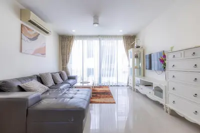 a living room with a couch and a tv at Laguna Parkside by Triple8 Asia in Laguna Phuket