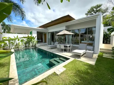 a villa with a swimming pool and a house at Trichada Tropical pool villa by Lofty in Bang Tao Beach