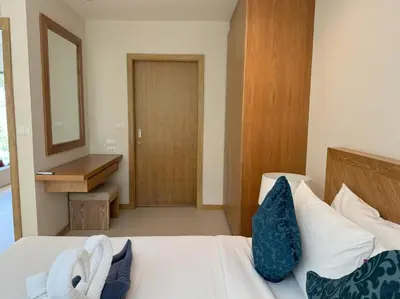 a bedroom with a bed with a mirror and a sink at Trichada Tropical pool villa by Lofty in Bang Tao Beach
