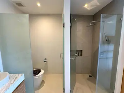 a bathroom with a glass shower and a toilet at Trichada Tropical pool villa by Lofty in Bang Tao Beach