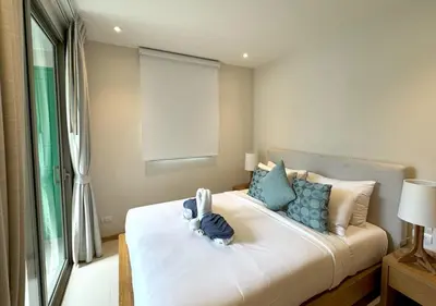 a bedroom with a bed with a stuffed animal on it at Trichada Tropical pool villa by Lofty in Bang Tao Beach