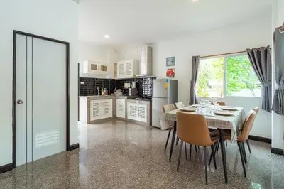 a kitchen and dining room with a table and chairs at Pool Villa 3 Bedrooms, Closeby Patong, Chic and Quiet in Kathu