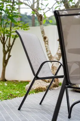 a white chair sitting on a sidewalk next to a table at Pool Villa 3 Bedrooms, Closeby Patong, Chic and Quiet in Kathu