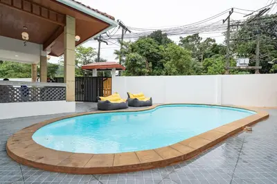 a large swimming pool with a wooden circle around it at Pool Villa 3 Bedrooms, Closeby Patong, Chic and Quiet in Kathu