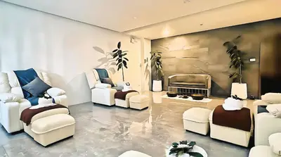 a living room with white chairs and a piano at Luxury studio near Nai Harn beach in Rawai Beach