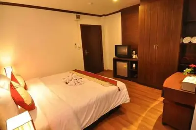a hotel room with a bed and a television at Hemingway's Hotel in Patong Beach