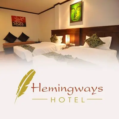 two beds in a hotel room with the words hammingways hotel at Hemingway's Hotel in Patong Beach