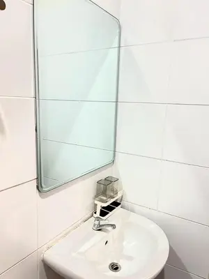 a white bathroom with a sink and a mirror at Yada House Alina Cottage in Nai Yang Beach