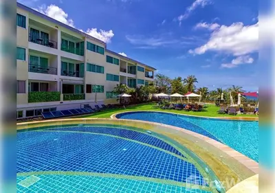 a resort with a swimming pool in front of a building at Karon Butterfly Residence in Kata Beach