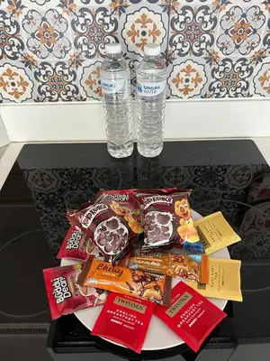 a table with two bottles of water and snacks at Karon Butterfly Residence in Kata Beach