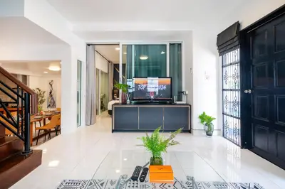 a living room with a television on a table at Cozystay Center of Patong near Bangla Road in Patong Beach