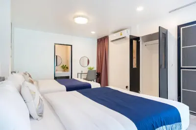 a bedroom with two beds with blue and white at Cozystay Center of Patong near Bangla Road in Patong Beach