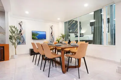 a dining room with a wooden table and chairs at Cozystay Center of Patong near Bangla Road in Patong Beach