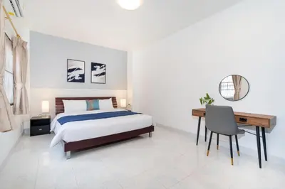 a bedroom with a bed and a desk and a desk at Cozystay Center of Patong near Bangla Road in Patong Beach