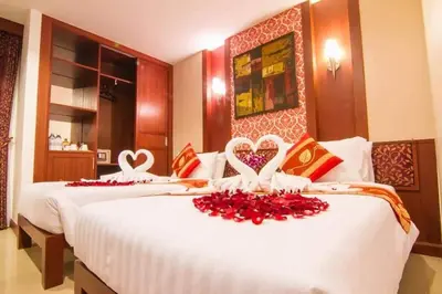 two beds in a hotel room with hearts on them at Patong Hemingways Hotel in Patong Beach