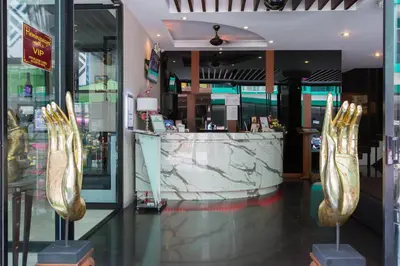 a store with a counter with gold shoes on display at Hemingways Silk Hotel in Patong Beach