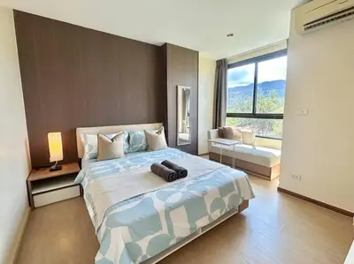 a bedroom with a large bed and a large window at 1 Large Bedroom in Prime Bangtao in Bang Tao Beach