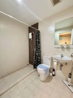 a bathroom with a toilet and a sink at 1 Large Bedroom in Prime Bangtao in Bang Tao Beach