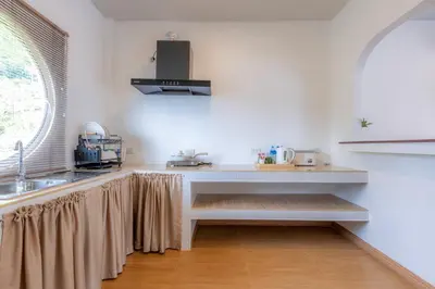 a kitchen with a sink and a counter top at Sunrise Serenity Phuket Resort in Karon Beach