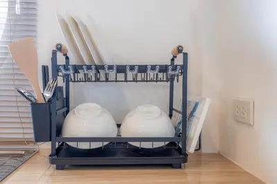 a shelf with two white pots and utensils at Sunrise Serenity Phuket Resort in Karon Beach