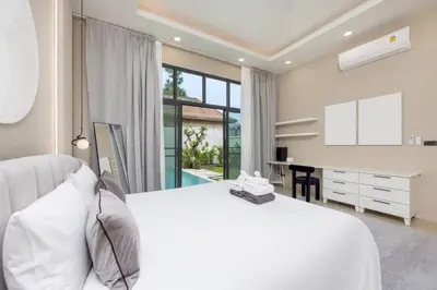 a white bedroom with a large bed and a desk at VILLA Hinako Private Pool Nai Harn Beach in Rawai Beach
