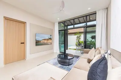 a living room with a couch and a large window at VILLA Hinako Private Pool Nai Harn Beach in Rawai Beach