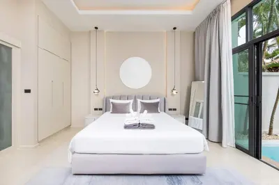 a bedroom with a white bed and a pool at VILLA Hinako Private Pool Nai Harn Beach in Rawai Beach