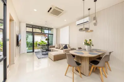 a dining room and living room with a table and chairs at VILLA Hinako Private Pool Nai Harn Beach in Rawai Beach