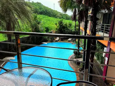 a view of a swimming pool from a balcony at Nai Harn Condominium in Rawai Beach