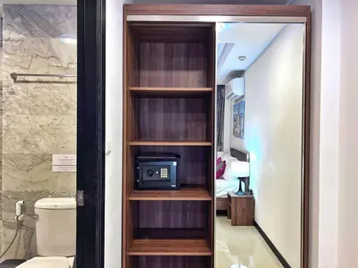 a book shelf with a television in a room at Nai Harn Condominium in Rawai Beach