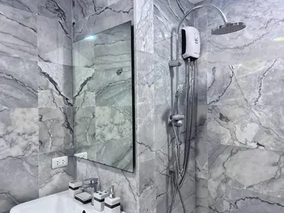 a bathroom with a shower and a sink at Nai Harn Condominium in Rawai Beach