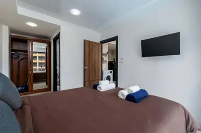 a bedroom with a bed with two pillows on it at 1 BR apartment 777 Beach Condotel in Mai Khao Beach