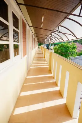 a walkway outside of a building at Bangtao Corner in Bang Tao Beach