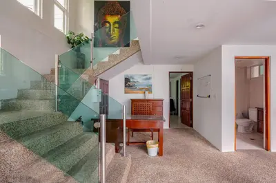 a staircase in a house with a desk and a stair case at Kamala Heights Villa in Kamala Beach