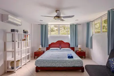a bedroom with a bed and a ceiling fan at Kamala Heights Villa in Kamala Beach