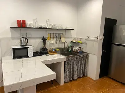 a kitchen with a counter with a microwave and a sink at Bestin Karon 1 - Apartment GF- 1 min from Karon beach in Karon Beach