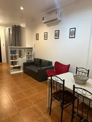 a living room with a couch and a table at Bestin Karon 1 - Apartment GF- 1 min from Karon beach in Karon Beach
